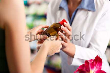 woman buying perfume in shop or store Stock photo © Kzenon