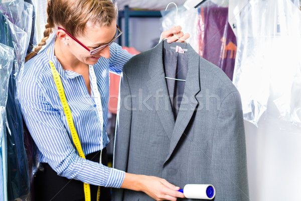 Cleaner in laundry shop checking clean clothes  Stock photo © Kzenon