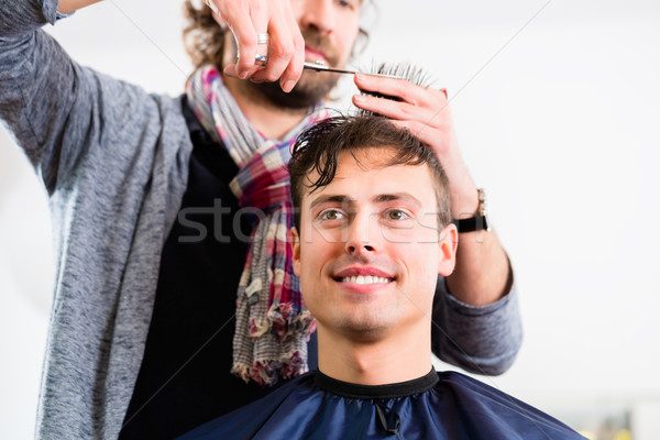 Barber trimming man hair in haircutter shop Stock photo © Kzenon