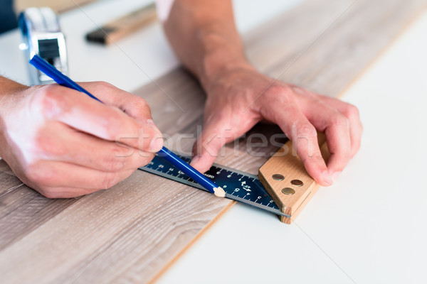 Carpenter marking cut on parquet piece  Stock photo © Kzenon