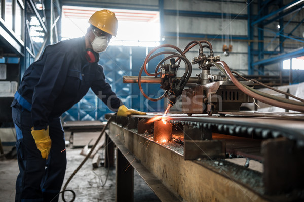 Asian worker using CNC plasma cutter Stock photo © Kzenon