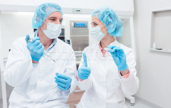 Scientists in biotech lab with pipette and sample dish Stock photo © Kzenon
