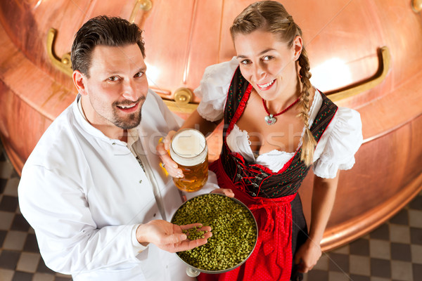 Stock photo: brewer and woman with beer glass in brewery