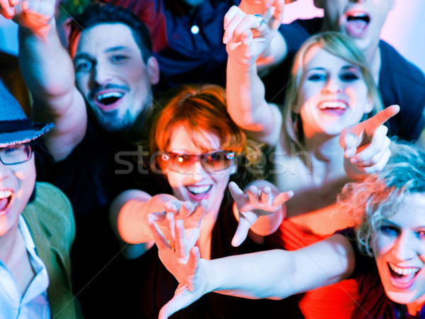 Cheering crowd in disco club Stock photo © Kzenon