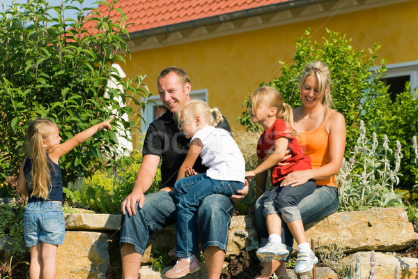 Family in front of home Stock photo © Kzenon