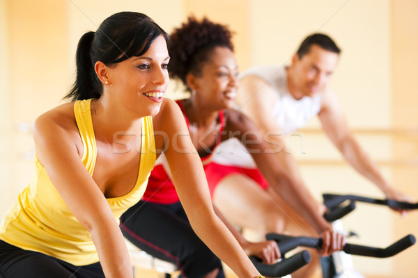 Bicycle Spinning in gym Stock photo © Kzenon