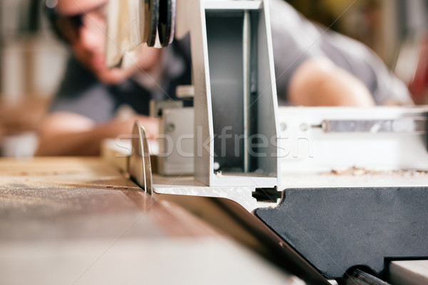 Carpenter using electric saw Stock photo © Kzenon