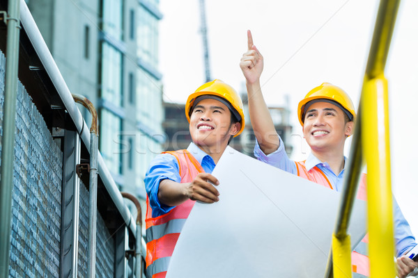 Asian Indonesian construction workers on building site Stock photo © Kzenon