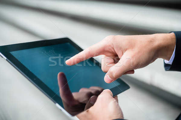 Businessman navigating on a tablet computer Stock photo © Kzenon