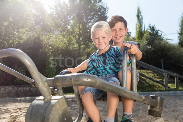 Two boys using digger on adventure playground in park Stock photo © Kzenon
