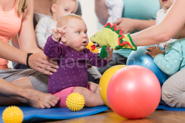 Stock photo: Young women in mother and child group playing with their baby ki