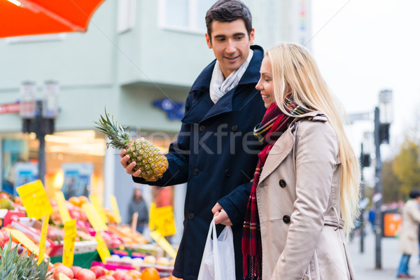 Couple buying groceries on farmers market stand Stock photo © Kzenon