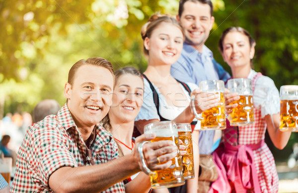 Stock photo: In Beer garden - friends drinking beer in Bavaria on Oktoberfest