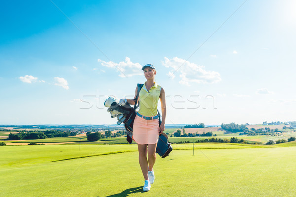 Stock photo: Full length rear view of an active woman carrying a blue stand b
