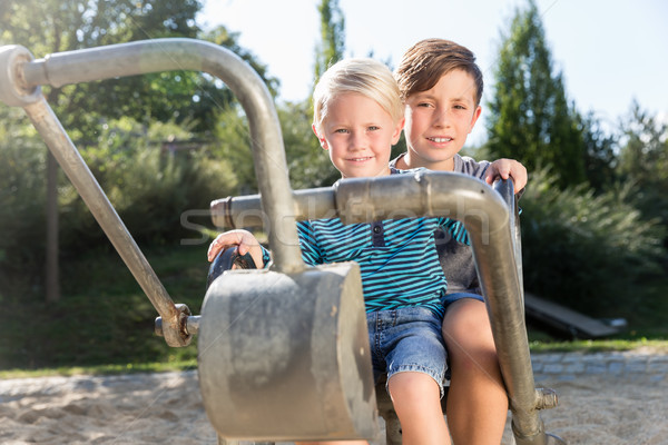 Two boys using digger on adventure playground in park Stock photo © Kzenon