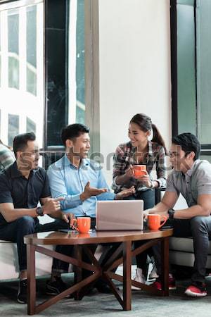 Team of four dedicated employees working together Stock photo © Kzenon