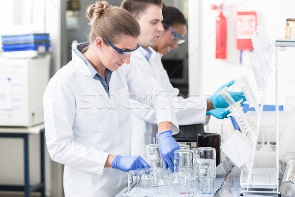 Female lab technician with safety goggles Stock photo © Kzenon
