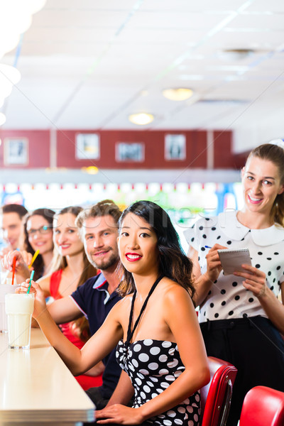 People in American diner or restaurant with milk shakes Stock photo © Kzenon