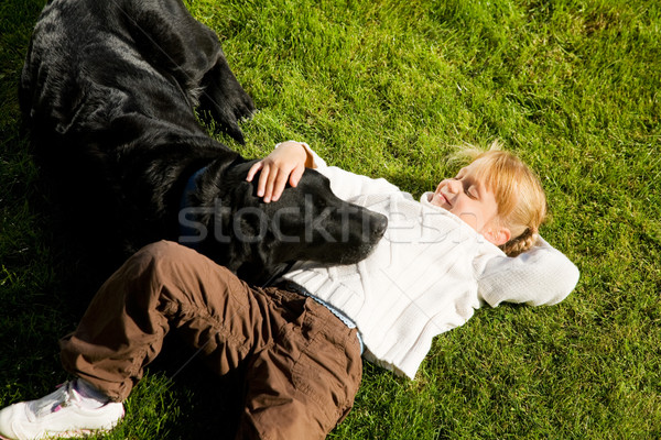 Girl petting dog Stock photo © Kzenon