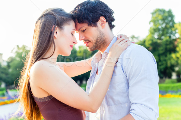 Tourist couple in city park hugging in love Stock photo © Kzenon