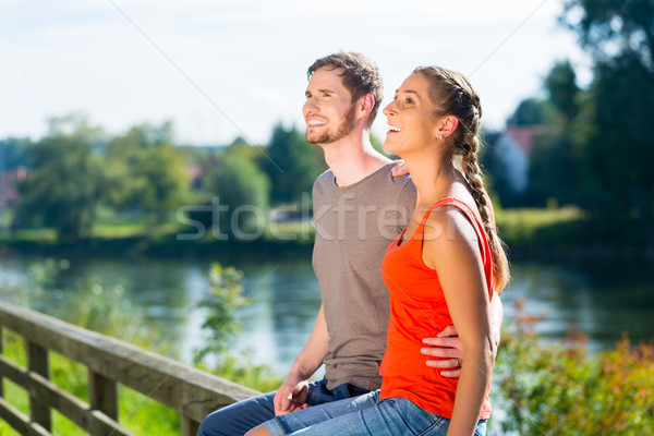Couple sitting at riverbank in summer Stock photo © Kzenon