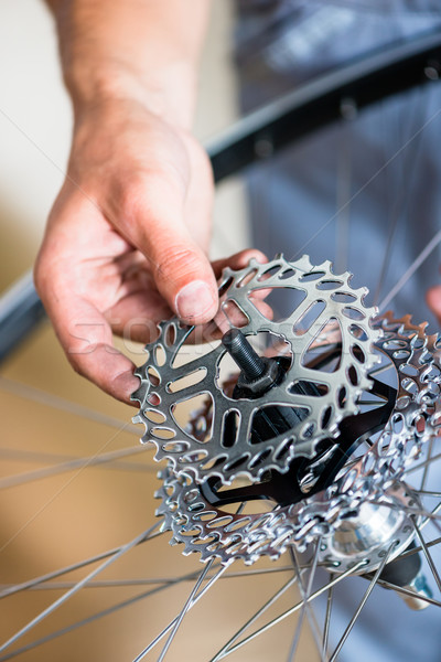 Mechanic repairing gears of bicycle Stock photo © Kzenon