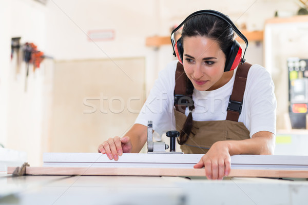 Carpenter woman working in her workshop Stock photo © Kzenon