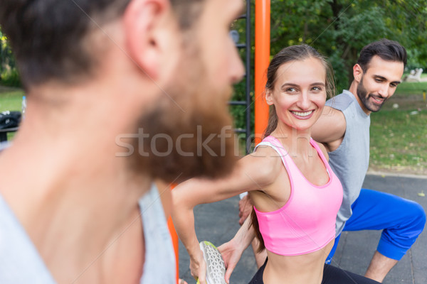 Attractive fit woman smiling during stretching routine while exe Stock photo © Kzenon