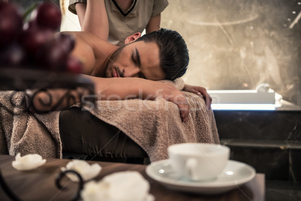 Young man lying down during traditional acupressure procedure Stock photo © Kzenon