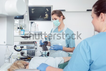 Doctor greeting patient before starting treatment Stock photo © Kzenon
