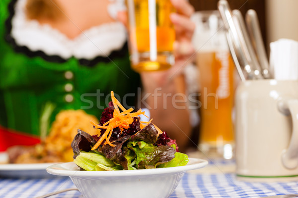 People in traditional Bavarian Tracht eating in restaurant or pub Stock photo © Kzenon