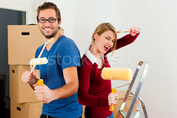 Young couple moving in new home Stock photo © Kzenon