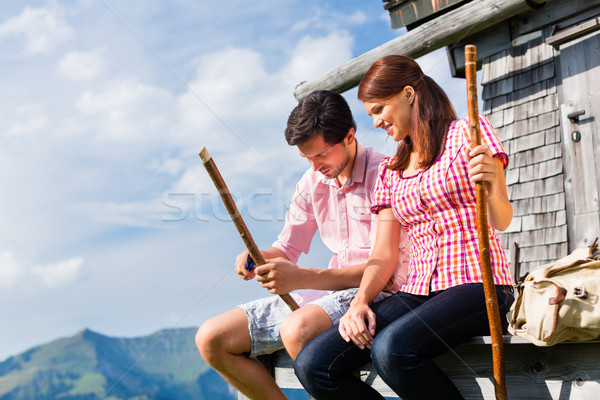 Alp mountains - Man and woman sitting at cabin Stock photo © Kzenon