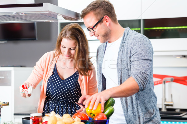 Couple cooking pasta in domestic kitchen Stock photo © Kzenon