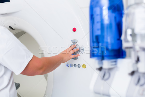 Nurse pressing button on CT machine in hospital Stock photo © Kzenon