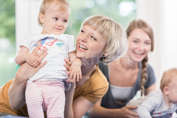 Young moms and their little children in mother and child course Stock photo © Kzenon