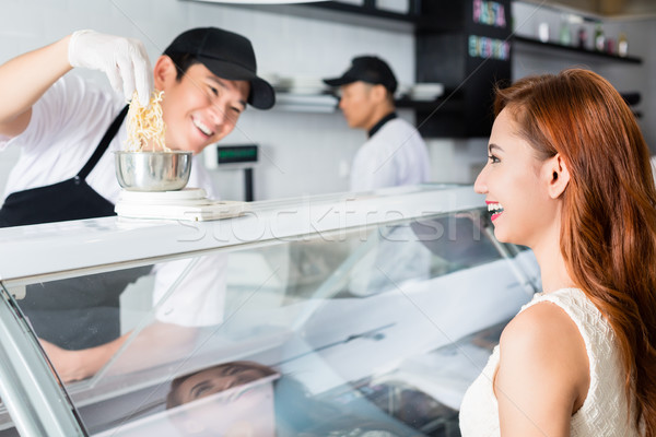 Laughing young man serving a pretty woman Stock photo © Kzenon