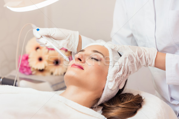 Beautiful woman relaxing during non-invasive facial treatment fo Stock photo © Kzenon