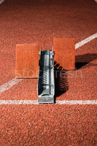Starrting blocks at cindertrack of athletics stadium Stock photo © Kzenon