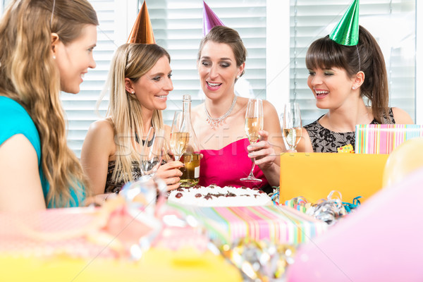 Best friends drinking champagne in front of a birthday cake Stock photo © Kzenon