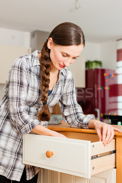 Young woman is assembling a cupboard Stock photo © Kzenon