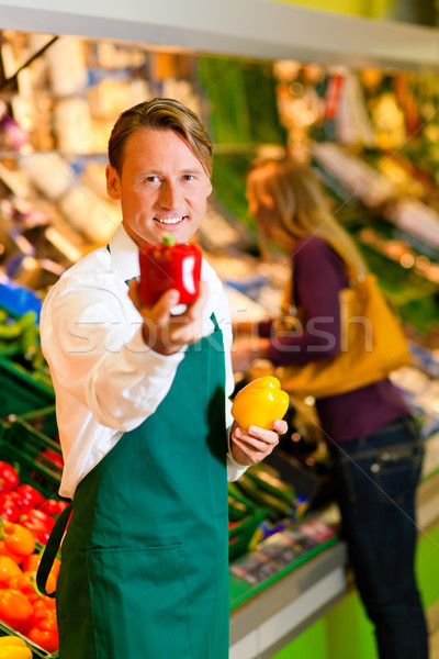 Man in supermarket as shop assistant Stock photo © Kzenon