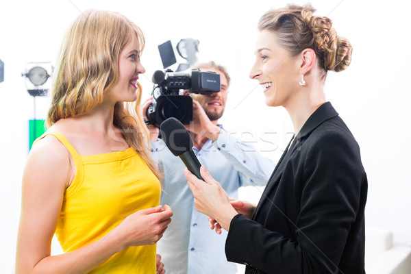 Reporter and cameraman shoot an interview Stock photo © Kzenon