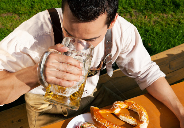 Man in Lederhosen drinking beer Stock photo © Kzenon