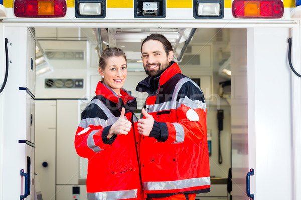 Stock photo: Emergency doctor in front of ambulance  
