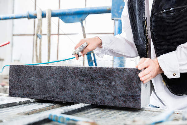 Stonemason working with compressed air at gravestone Stock photo © Kzenon