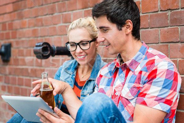 Stock photo: couple reading city guide before making scooter tour in Berlin