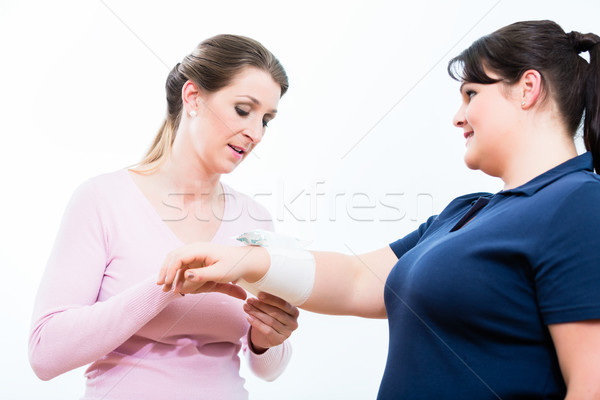 Women in First aid course learning to apply bandages Stock photo © Kzenon