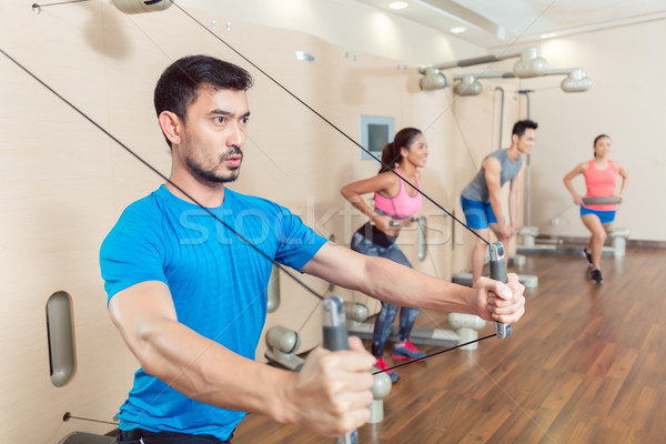 Determined young man exercising with resistance bands Stock photo © Kzenon