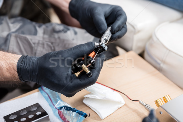 Close-up of the hands of a male artist preparing a professional tattoo machine Stock photo © Kzenon